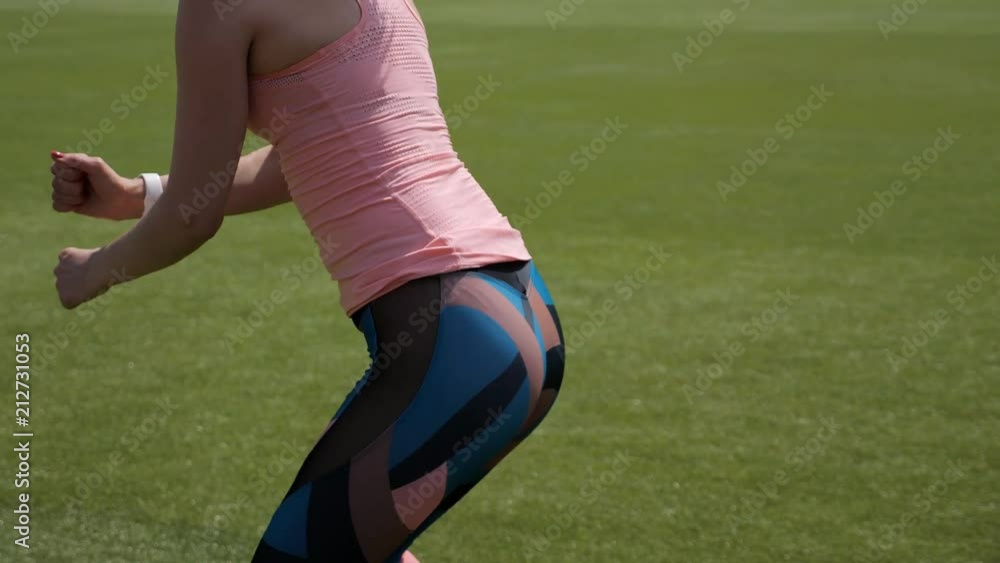 Young girl doing fitness exercise at the stadium outdoors. Healthy, sport and fitness concept, 4k Young girl doing fitness exercise at the stadium outdoors. Healthy, sport and fitness concept, 4k