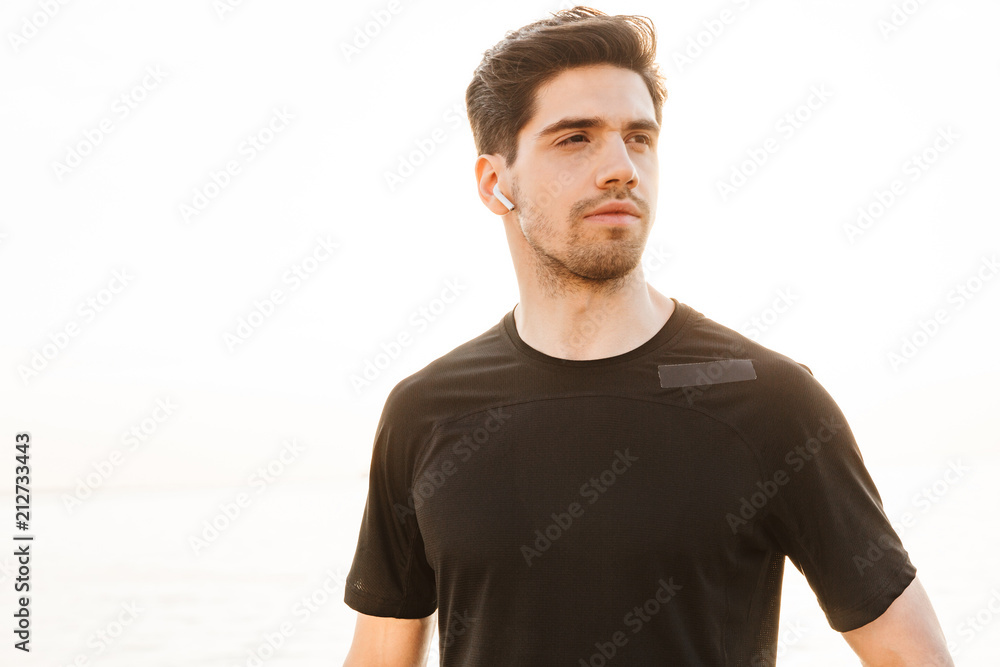 Fototapeta premium Young sportsman standing outdoors