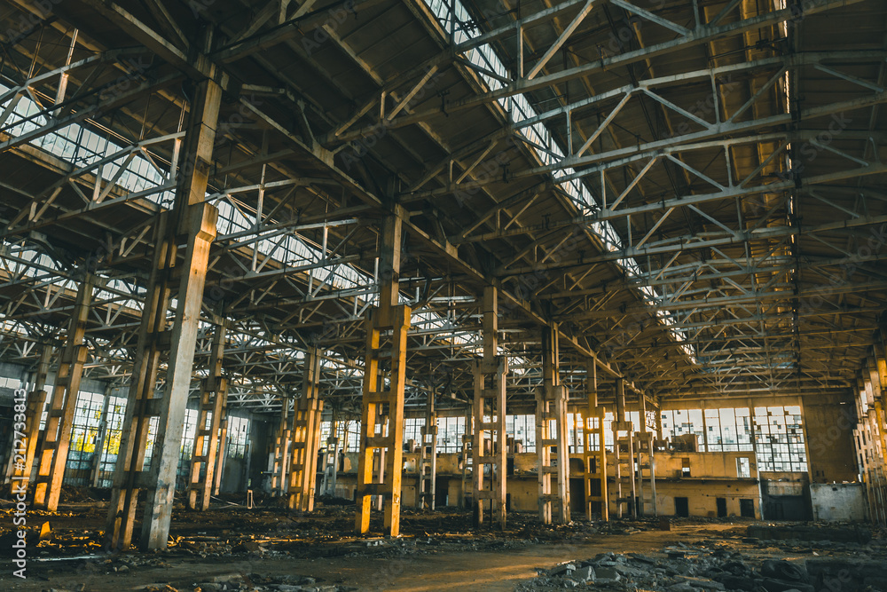 Abandoned ruins of industrial factory building inside, corridor view, perspective and sunlight, creepy ruins and demolition concept