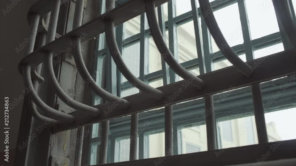 Prison cell window bars at day - dynamic shot Prison cell window bars at day - dynamic shot