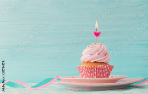pink cupcake on blue wooden background