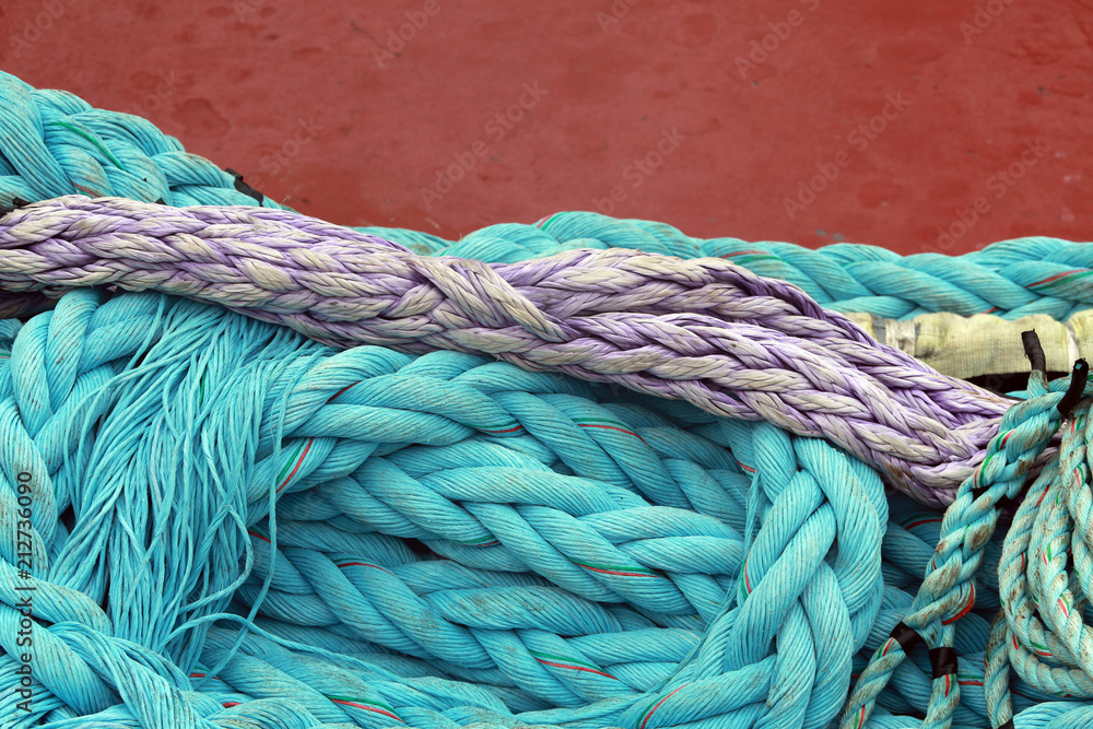 purple and blue green moring lines against red hull of ship, Bermuda