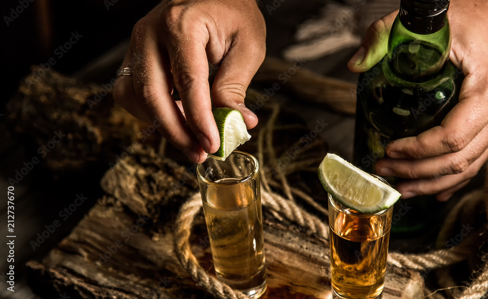 bartender adds lime to tequila - obrazy, fototapety, plakaty 