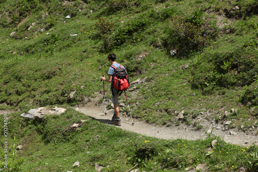 male teenager walking alone on a mountain trial