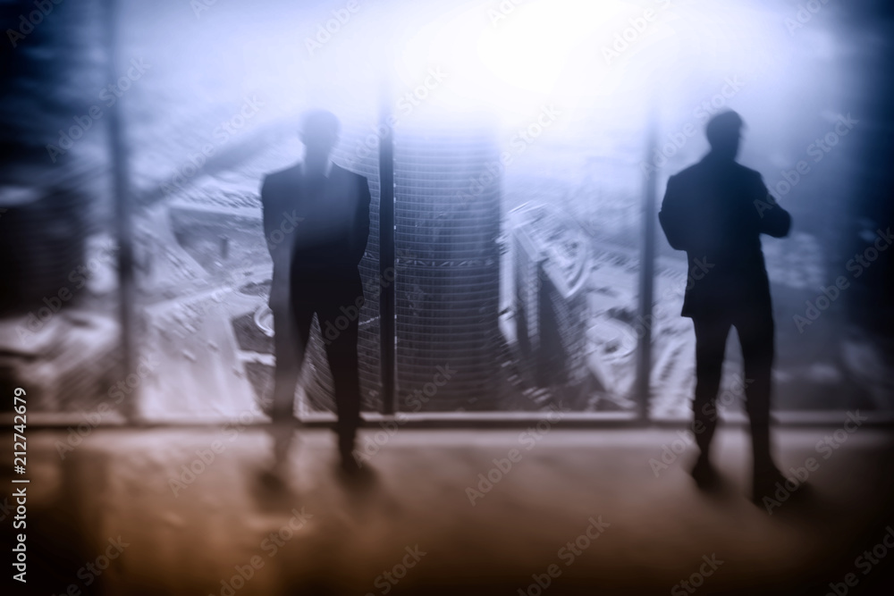 two businessman at the window on the background of the city two businessman at the window on the background of the city