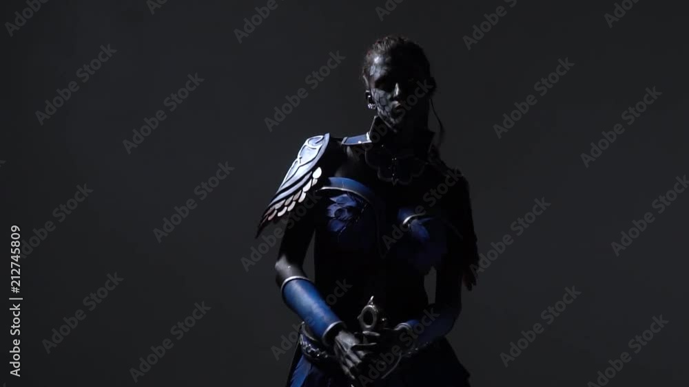 Pompous dark warrior in light blue armor pose with epic sword, slow motion Pompous dark warrior in light blue armor pose with epic sword, slow motion