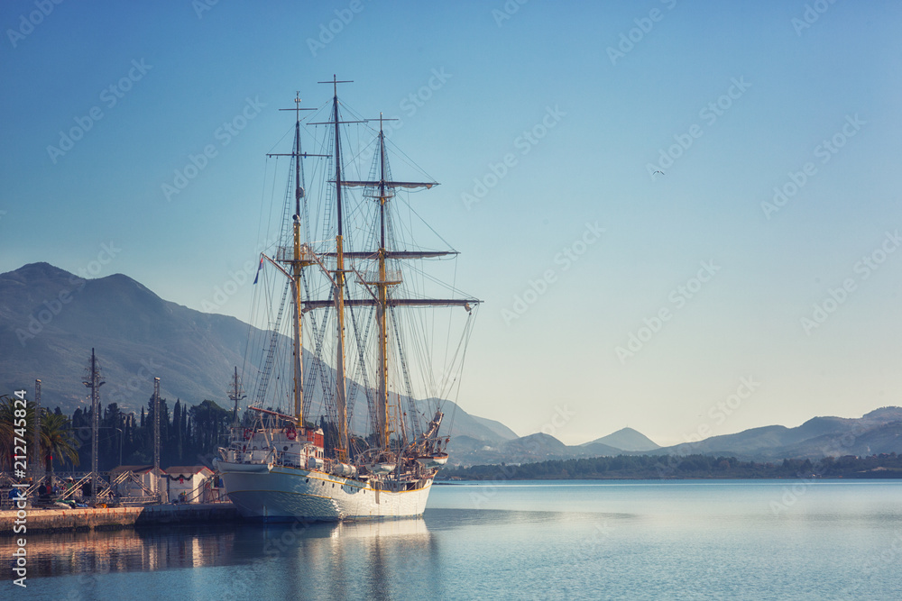 Night Embankment in Tivat, view of an old sailing ship. Montenegro