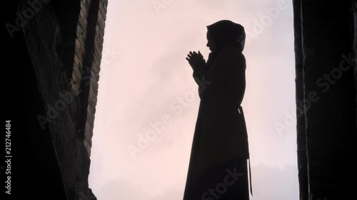 Young refugee muslim woman in hijab standing in abandoned building, frightened and terrified photo