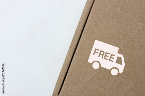 free delivery, business,online shopping, ecommerce and delivery service concept - brown box with note 
