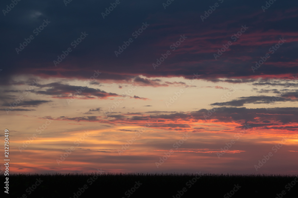 Romantic sunset with black silhouette in the foreground