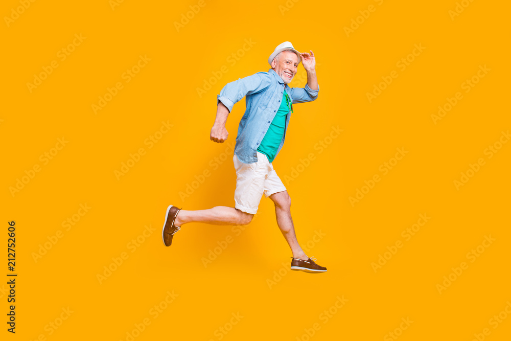 Fototapeta premium Happiness emotion facial expressing hold hand empty place concept. Turned full length size view photo portrait of cheerful excited lovely cute handsome gentleman jumping up isolated vivid background