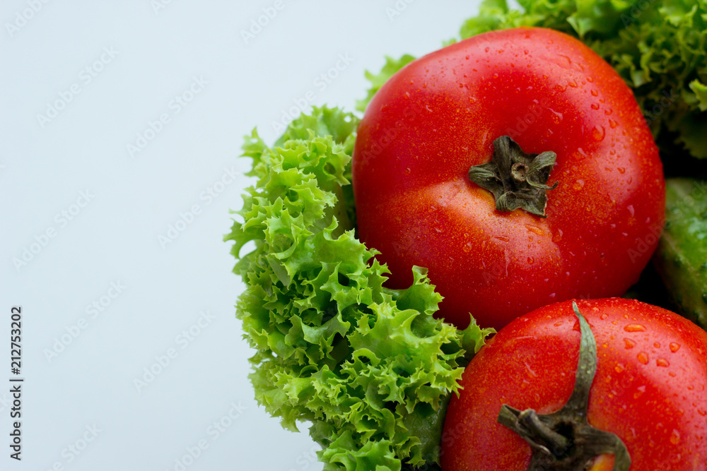 Fresh red tomatoes, green salad and cucumber Fresh red tomatoes, green salad and cucumber