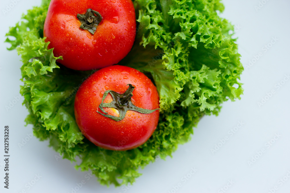 Fresh red tomatoes and green salad Fresh red tomatoes and green salad