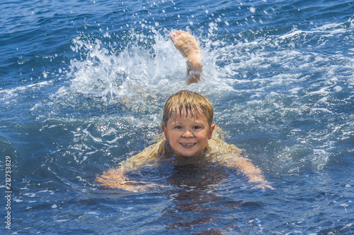 Wallpaper Mural boy has fun playing in the waves Torontodigital.ca