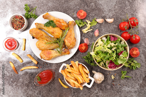 grilled chicken leg with french fries and salad