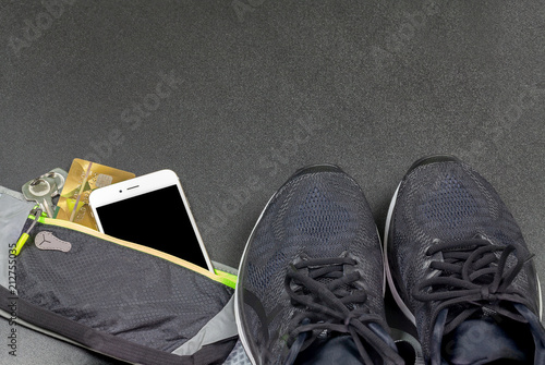 bag, telephone, key and running shoes for sports on a dark background photo