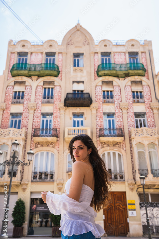 Young lady standing near beautiful building