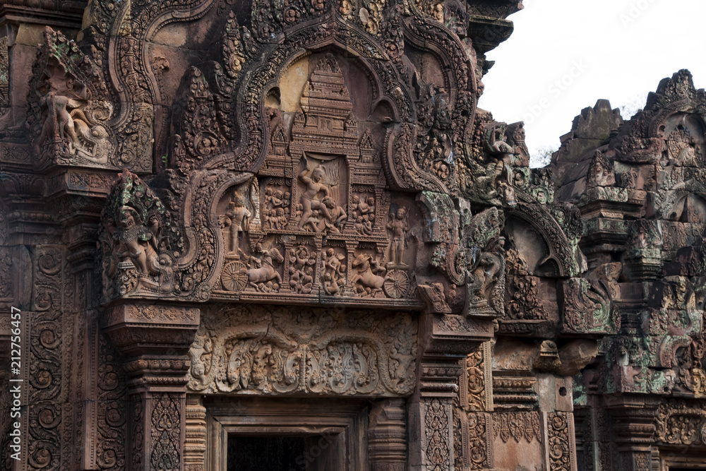Angkor Cambodia, Krishna killing the demon king Kamsa bas relief over the western pediment, southern library at the 10th century Banteay Srei temple