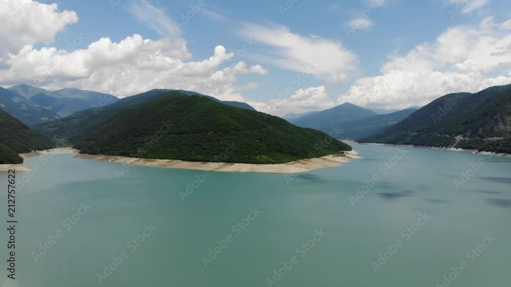 Aerial photography of a blue lagoon surrounded by green hills, a beautiful clear sky. 4k Aerial photography of a blue lagoon surrounded by green hills, a beautiful clear sky. 4k