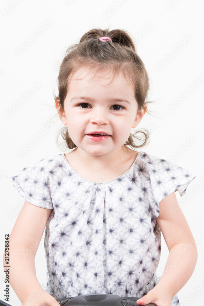 Studio portrait of a beautiful young child girl posing against a white background Studio portrait of a beautiful young child girl posing against a white background