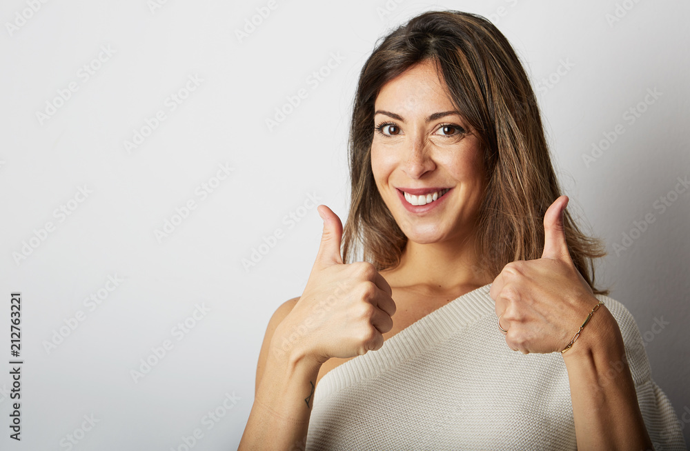 Happy ecstatic young brunette woman with long hair totally agrees over empty white background.Girl showing ok sign and thumbs up,smiling.Positive human emotions, reaction, gestures and body language Happy ecstatic young brunette woman with long hair totally agrees over empty white background.Girl showing ok sign and thumbs up,smiling.Positive human emotions, reaction, gestures and body language