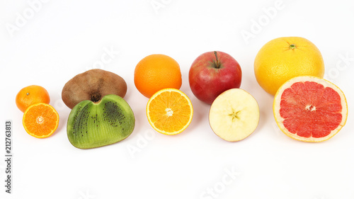 different fruit whole and sliced on white background © photosaint