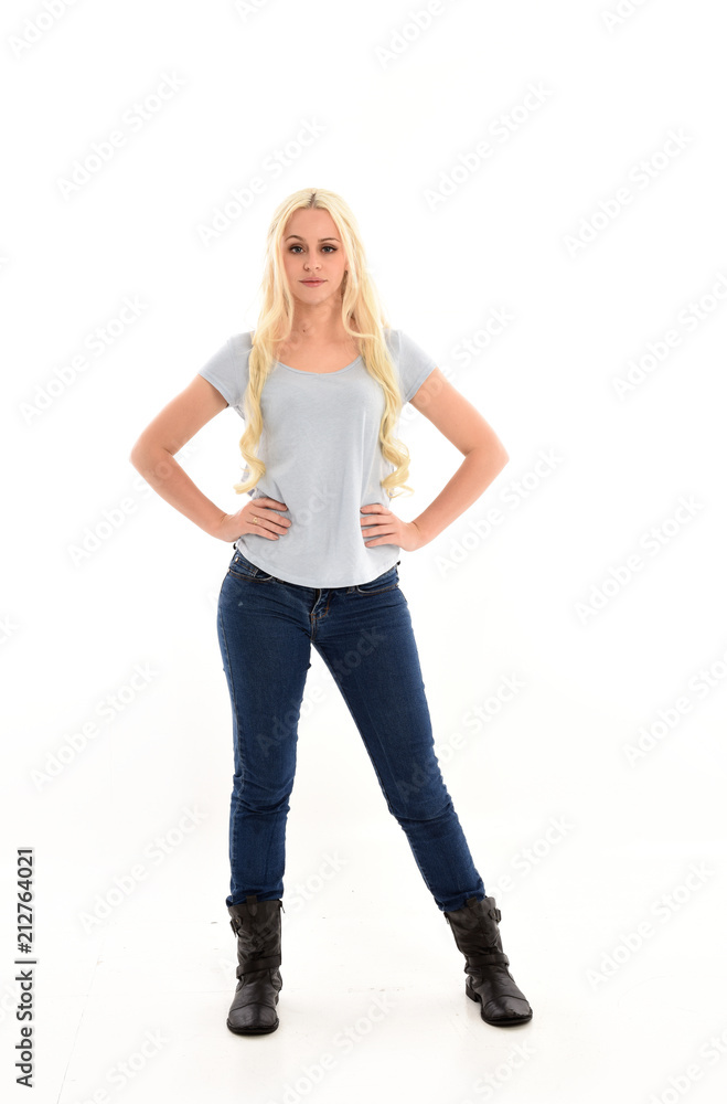 full length portrait of blonde girl wearing blue shirt and jeans, standing pose isolated on white studio background. full length portrait of blonde girl wearing blue shirt and jeans, standing pose isolated on white studio background.