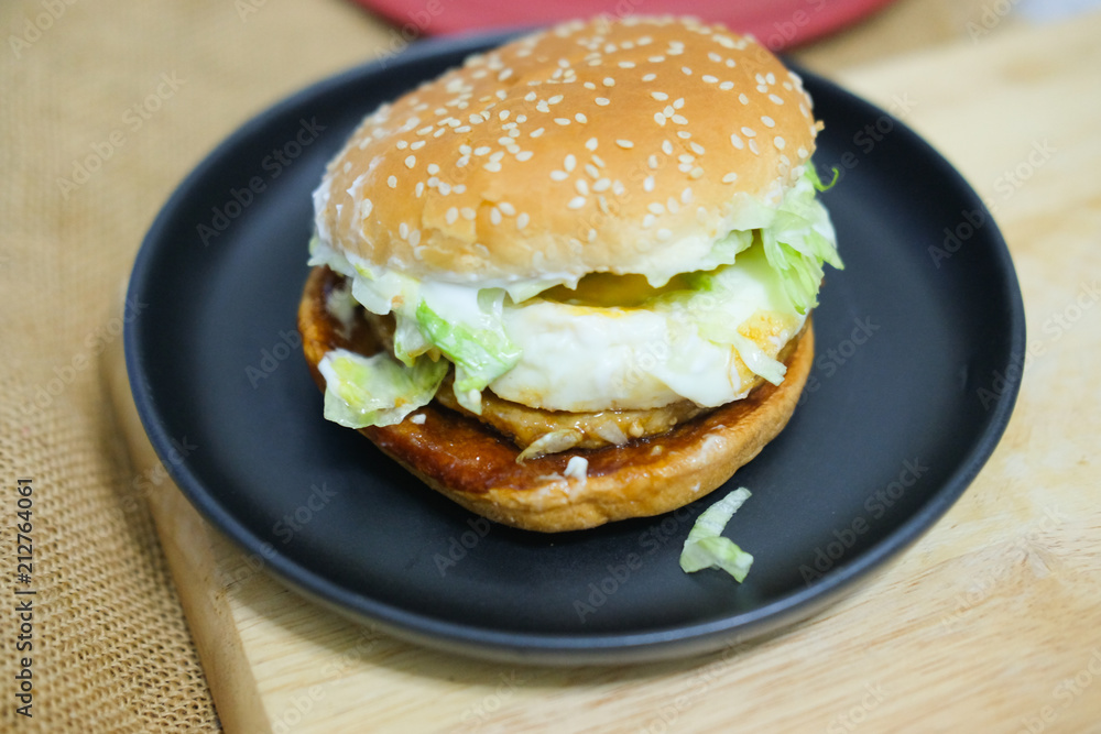 Tasty burger with pork and fried egg Tasty burger with pork and fried egg