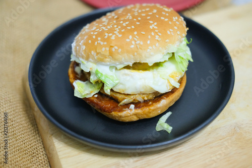 Tasty burger with pork and fried egg