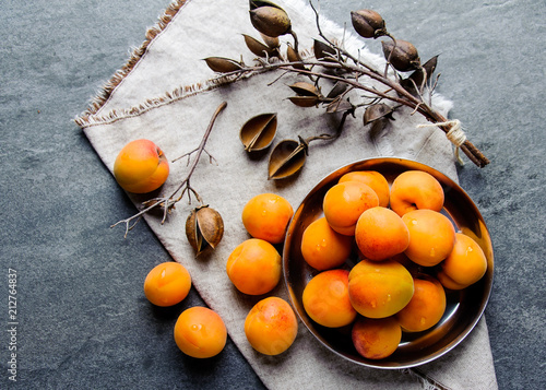 Apricots in a metal pial are stacked photo