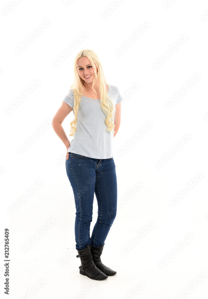 full length portrait of blonde girl wearing blue shirt and jeans, standing pose isolated on white studio background. full length portrait of blonde girl wearing blue shirt and jeans, standing pose isolated on white studio background.