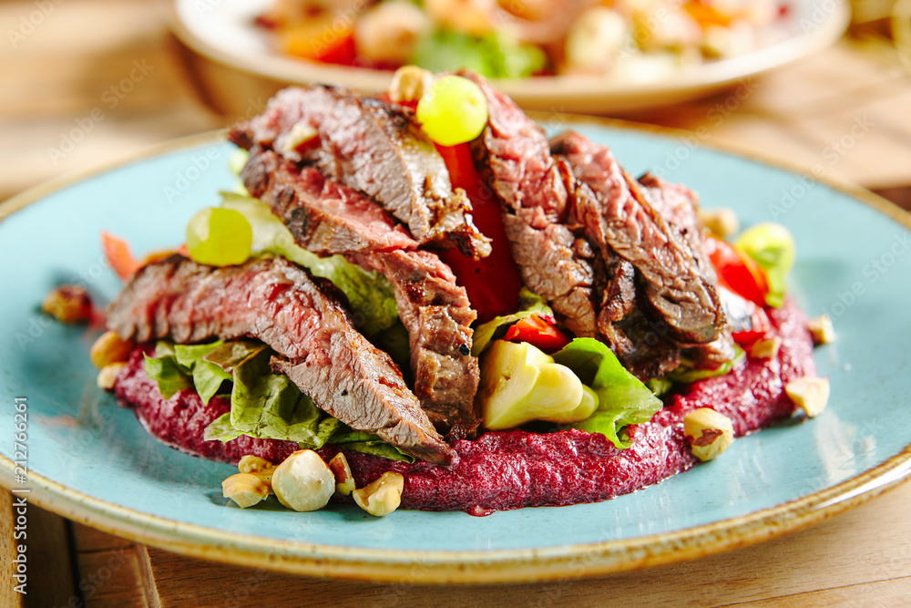 Salad with Grilled Prime Beef or Thick Slices of Marbling Steak on Blue Plate