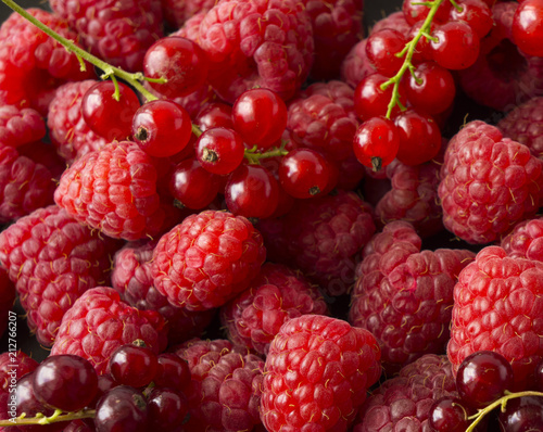 Background of raspberries and red currants. Fresh berries closeup. Top view. Background of red berries.