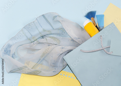 gift bag with a handle, part of a dress on a turquoise background © Yalana