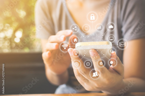 Canvas Print Asian woman hand using smartphone with icon technology communication and internet of things (IOT)