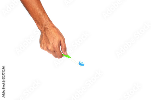healthy adult hand holding a green brush with blue fur on white background isolated