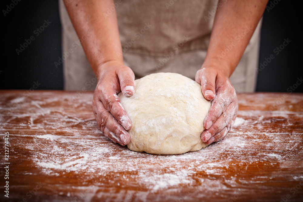 Baker shaping bread dough