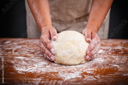 Baker shaping bread dough