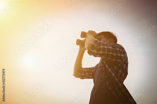 Close-up Of Asian man Hand Holding / looking / watching using Binoculars with copyspace, Technology Binoculars background concept