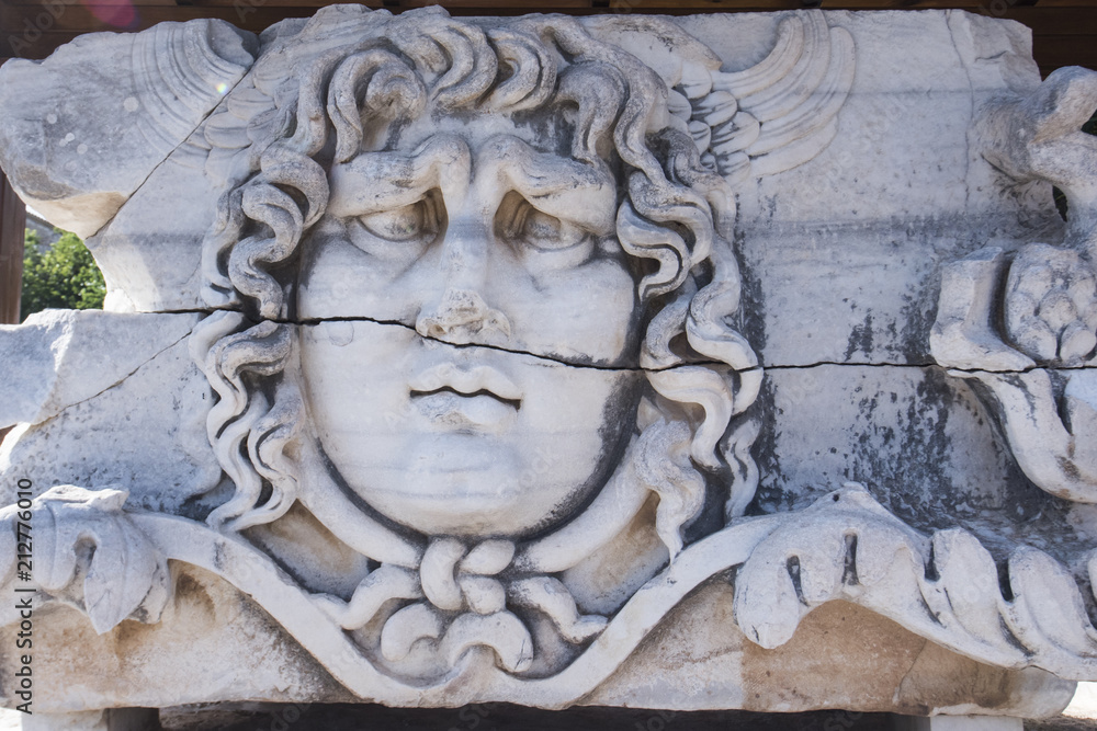Partly ruined Head of Medusa in the temple of Apollo, Didim, Turkey