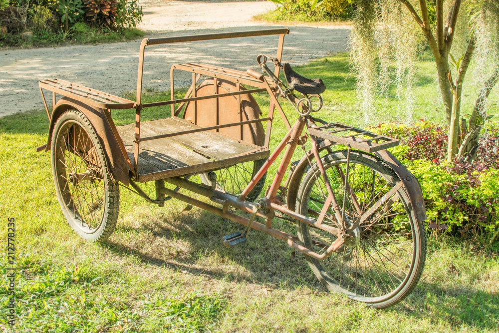 Old tricycle Parked on the lawn