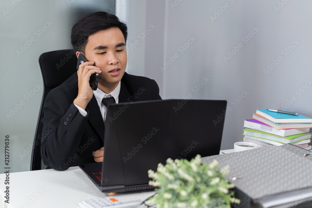 business man talking on mobile phone and using laptop business man talking on mobile phone and using laptop