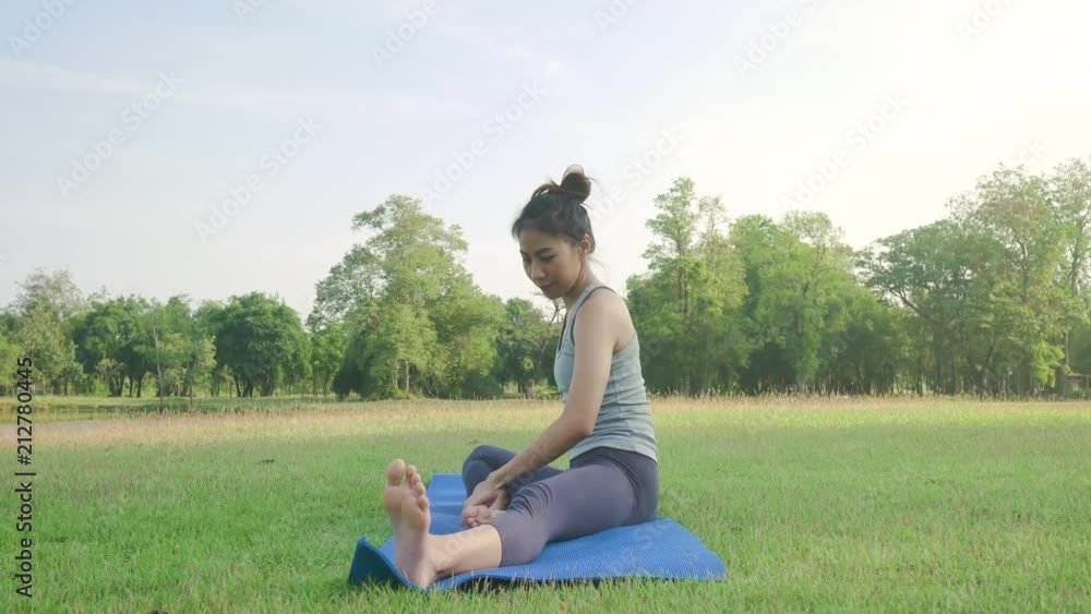 Young asian woman yoga outdoors keep calm and meditates while practicing yoga to explore the inner peace. Yoga and meditation have good benefits for health. Yoga Sport and Healthy lifestyle concept. Young asian woman yoga outdoors keep calm and meditates while practicing yoga to explore the inner peace. Yoga and meditation have good benefits for health. Yoga Sport and Healthy lifestyle concept.