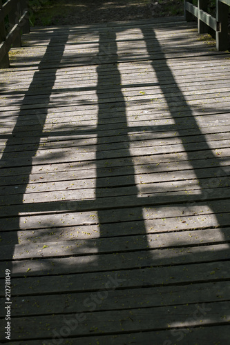 on a wooden bridge shadows in the form of strips