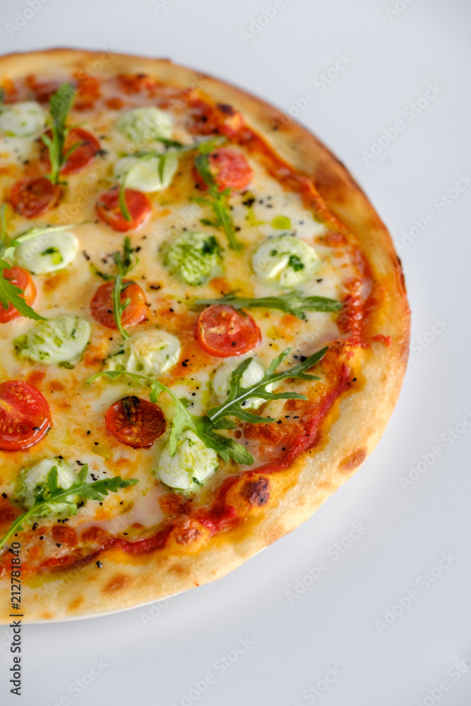 Fototapeta Pizza with tomatoes and arugula and mozzarella