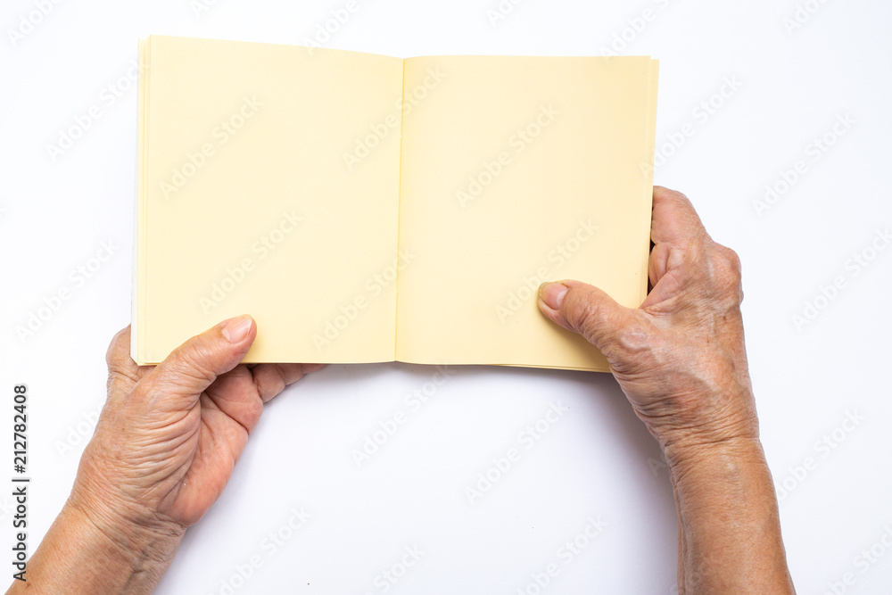 Senior woman's hand holding on notebook isolated on white background, Stationery concept Senior woman's hand holding on notebook isolated on white background, Stationery concept