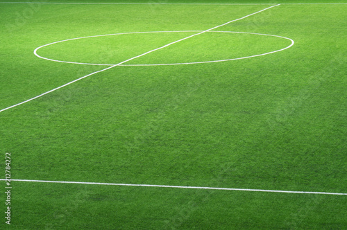Fragment of a fresh green football field with a marking for the background