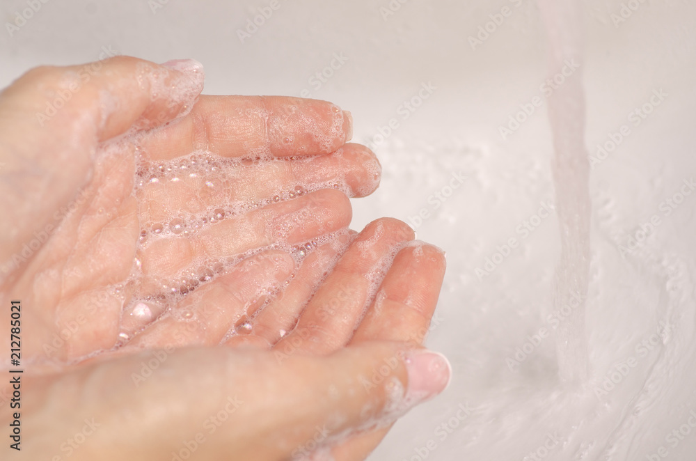 Washing  hands in the washbasin soap water bathroom clean care skin