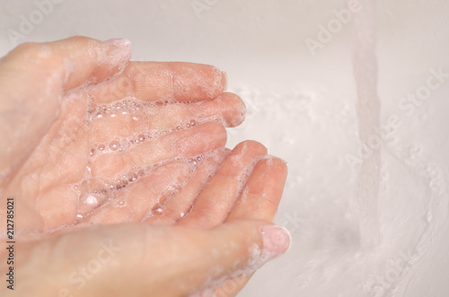 Washing hands in the washbasin soap water bathroom clean care skin