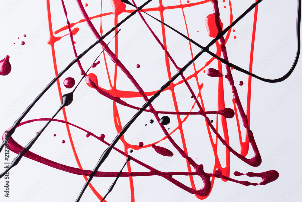 Nail polish on a white background in the form of strips and drops Nail polish on a white background in the form of strips and drops